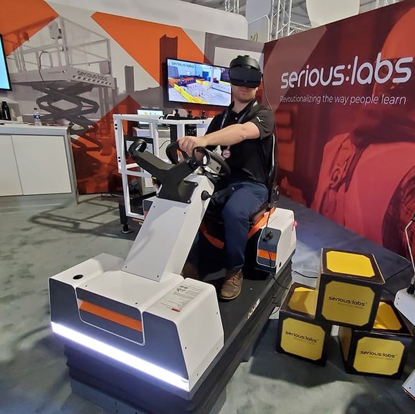Men driving a simulator with VR headset